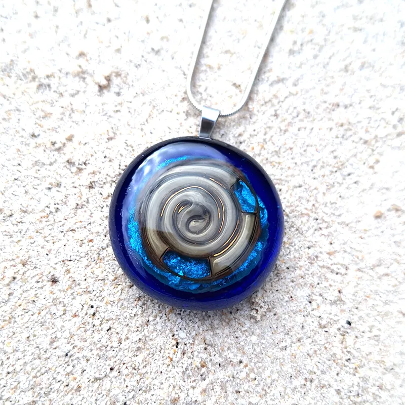blue pendant with spiral symbol